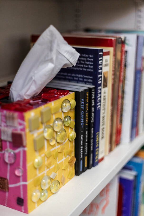 Colorful Kleenex box and books on creativity